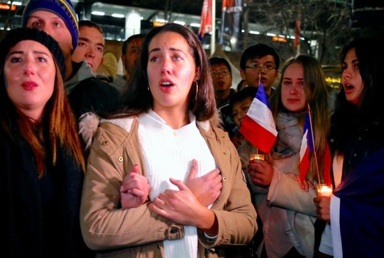 Members of the Australian French community mourn during a July 15 candlelight vigil in central Sydney to remember the victims of the Bastille Day truck attack in Nice, France. A truck loaded with weapons and hand grenades drove onto a sidewalk in Nice for more than a mile July 14, killing more than 80 people. CNS photo/David Gray, Reuters