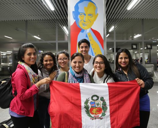 World Youth Day pilgrims from Lima, Peru, pose for a photo in front of an image of St. John Paul II after arriving July 23 at John Paul II International Airport in Krakow, Poland. CNS photo/Bob Roller