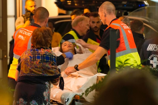 Paramedics rush a young woman to a waiting ambulance July 14 as they evacuate victims from the scene where a truck crashed into the crowd during the Bastille Day celebrations in Nice, France. More than 80 people were killed and the death toll was rising. CNS photo/Oliver Anrigo, EPA