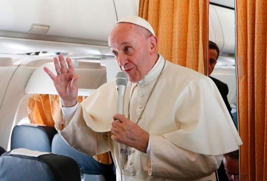 Pope Francis gestures as he speaks to journalists aboard his flight from Rome to Krakow, Poland, July 27. The pope is attending World Youth Day in Krakow. CNS photo/Paul Haring