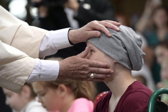 Pope Francis blesses a girl during a visit to the Children's University Hospital in Krakow, Poland, July 29. CNS photo/L'Osservatore Romano via Reuters