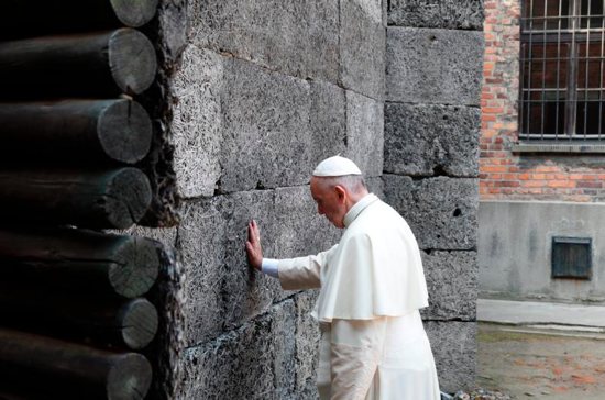 Pope Francis touches the death wall at the Auschwitz Nazi death camp in Oswiecim, Poland, July 29. CNS photo/Paul Haring