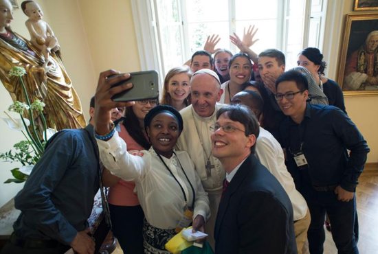 Pope Francis poses for a selfie with young people attending World Youth Day during a lunch in Krakow, Poland, July 30. CNS photo/L'Osservatore Romano, handout
