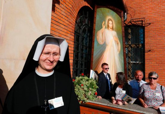A nun is seen near an image of Jesus of Divine Mercy before Pope Francis' arrival to visit the Divine Mercy Shrine in Lagiewniki, a suburb of Krakow, Poland, July 30. CNS photo/Paul Haring)