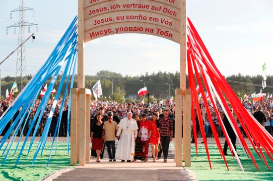 Pope Francis walks with pilgrims through the Door of Mercy as he arrives for a prayer vigil as part of World Youth Day at the Field of Mercy in Krakow, Poland, July 30. CNS photo/Paul Haring