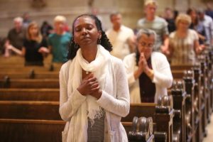 Eleni Demissie of the Cathedral of St. Paul prays during Mass for the Preservation of Peace and Justice at the Cathedral of St. Paul July 8. Dave Hrbacek/The Catholic Spirit