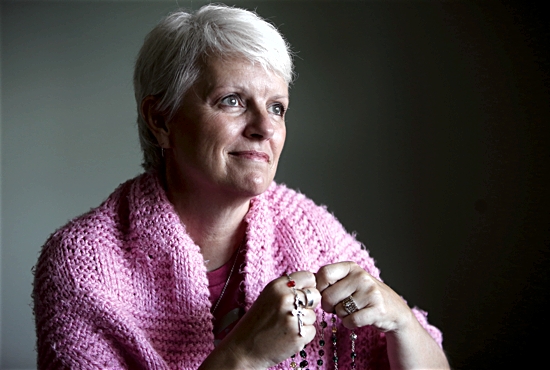 Rhonda Zweber of St. Michael in Prior Lake uses a rosary and prayer shawl in her own battle with cancer and to deepen the faith that inspires her to serve others with the disease. Dave Hrbacek/The Catholic Spirit