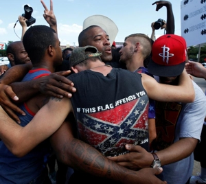 African-American and white men embrace after taking part in a prayer circle July 10 following a Black Lives Matter protest in Dallas. Theologians and justice advocates have called upon the church to better address racism as a life issue and see it as an "intrinsic evil." CNS photo/Carlo Allegri, Reuters