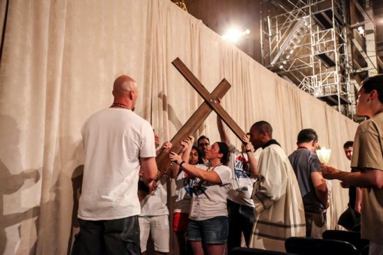 Young adults carry the cross during Stations of the Cross at the Basilica of the National Shrine of the Immaculate Conception in Washington July 30 as a way of being in unison with World Youth Day pilgrims in Krakow, Poland. CNS photo/Brian Searby, Catholic Standard