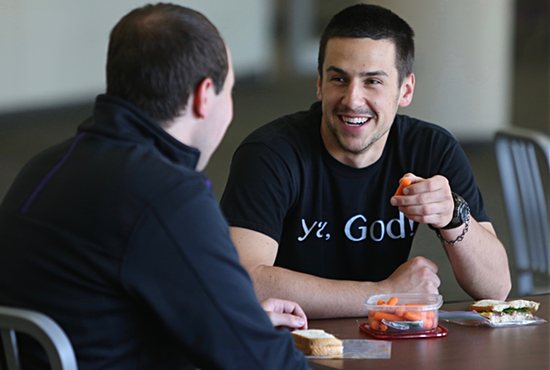 Austin Riordan, right, eats lunch and talks with student Robert Klemm. Dave Hrbacek/The Catholic Spirit