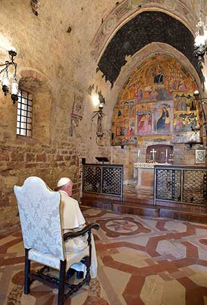 Pope Francis prays in the Portiuncola, the chapel inside the Basilica of St. Mary of the Angels, in Assisi, Italy, Aug. 4. CNS/L'Osservatore Romano 