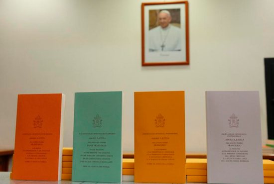 Copies of Pope Francis' apostolic exhortation on the family, "Amoris Laetitia" ("The Joy of Love"), are seen during the document's release at the Vatican April 8. The exhortation is the concluding document of the 2014 and 2015 synods of bishops on the family. CNS photo/Paul Haring