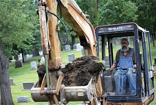 Deacon Joe Kittok digs a grave at Calvary Cemetery in Delano. He estimates he digs about 300 graves a year in 30 cemeteries in Delano and surrounding communities. Dave Hrbacek/ The Catholic Spirit