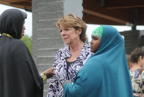 Kathy Langer, director of social concerns for Catholic Charities of the Diocese of St. Cloud, Minn., center, talks with Maryan Ahmed and Fatumo Ukash following a Sept. 18 news conference organized by the local Somali-American community in St. Cloud after a knife-wielding man injured nine people the previous day at a shopping mall. Bishop Donald J. Kettler of St. Cloud called for prayers for those impacted by the violence. CNS photo/Dianne Towalski, The Visitor