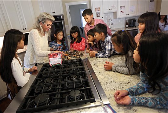 Jean Mulvahill works with her kids to make afternoon snacks in the kitchen. Dave Hrbacek/The Catholic Spirit