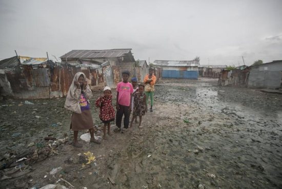 Hatian children stand in mud outside their homes Oct. 3 in Cite Soleil, a slum in Port-au-Prince, hours before Hurricane Matthew hit the island nation. Hurricane Matthew roared into the southwestern coast of Haiti Oct. 4, threatening a largely rural corner of the impoverished country with devastating storm conditions as it headed north toward Cuba and the eastern coast of Florida. CNS photo/Bahare Khodabande, Reuters