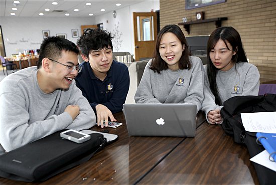 From left, Totino-Grace High School juniors Frank Chen, Calisto Zhang, Avelyn Lee and Olivia Song study in the residence where they live on campus in Fridley. Lee is from Korea, and the others are from China. Dave Hrbacek/ The Catholic Spirit