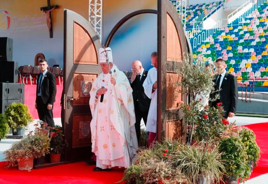 Pope Francis walks through a Holy Door as he arrives to celebrate Mass at Mikheil Meskhi Stadium in Tbilisi, Georgia, Oct. 1. CNS photo/Paul Haring