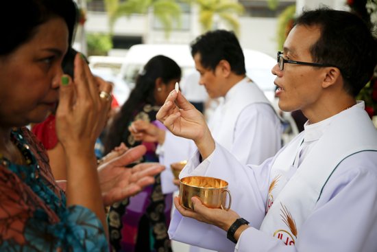 Faithful receive Communion in Bangkok Dec. 25, 2015. Four cardinals said they formally asked Pope Francis to clarify his teaching on Communion for the divorced and civilly remarried and have not received a response in two months. CNS 