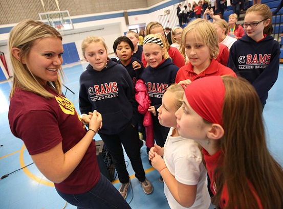 Katie Spotz, left, talks with students at Sacred Heart Catholic School in Robbinsdale after her presentation there Nov. 15. Dave Hrbacek/The Catholic Spirit