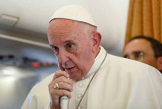 Pope Francis answers questions from journalists aboard his flight from Malmo, Sweden, to Rome Nov. 1. CNS/Paul Haring