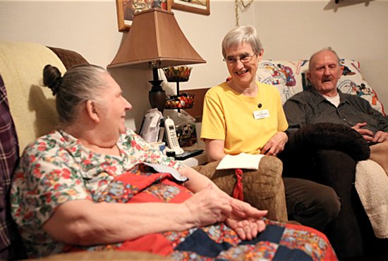 School Sister of Notre Dame Bernadette Welter, center, visits with Jane and George Joyner in their St. Paul home Nov. 30. Sister Bernadette works as a homemaker for the couple with West 7th Keystone Community Services in St. Paul. Dave Hrbacek/The Catholic Spirit
