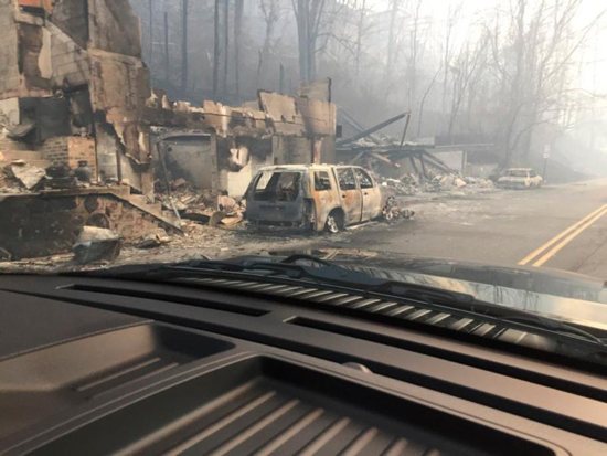 Burned buildings and cars are seen Dec. 1 in Gatlinburg, Tenn., in the aftermath of wildfires. Raging wildfires fueled by high winds claimed the lives of at least seven people, forced the evacuation of thousands, including Father Antony Punnackal of St. Mary's Church, and damaged hundreds of buildings in the popular mountain resort town. CNS photo/courtesy Tennessee Highway Patrol, handout via Reuters