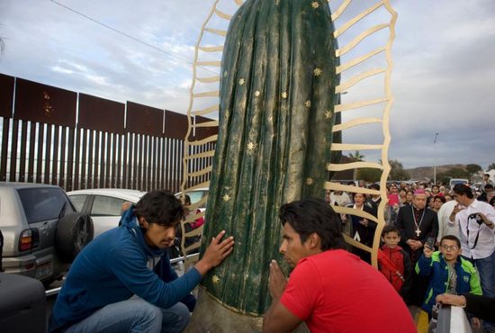 A statue of the Our Lady of Guadalupe is carried in a truck during a procession to the U.S.-Mexico border fence in Tijuana, Mexico, where Mass was celebrated. The Mass and a procession with a statue of Our Lady of Guadalupe were a call to remember and pray for migrants and were led by Archbishop Francisco Moreno Barron of Tijuana. CNS photo/David Maung