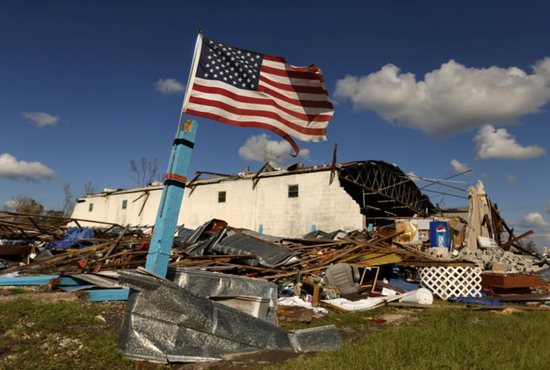A U.S. flag is seen amid rubble Oct. 11 after Hurricane Michael swept through Panama City, Fla.