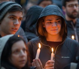 People mourn during a candlelight vigil Oct. 27 for victims of the shooting that killed eleven people at the Tree of Life Synagogue in Pittsburgh. Robert Bowers opened fire that morning during a service at the synagogue, also wounding at least six others, including four police officers, authorities said. 