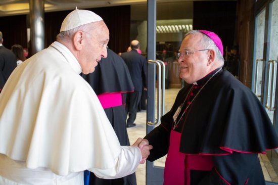 Pope Francis greets Archbishop Charles J. Chaput of Philadelphia before a session of the Synod of Bishops on young people, the faith and vocational discernment at the Vatican