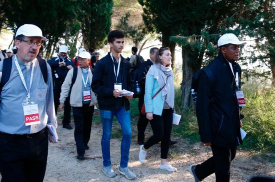 Sebastian Duhau, a synod observer from Australia, and Emilie Callan, a synod observer from Canada, participate in a pilgrimage hike from the Monte Mario nature reserve in Rome to St. Peter's Basilica at the Vatican Oct. 25. Cardinal Christoph Schonborn of Vienna said synodality refers to all the baptized taking responsibility for the church and its mission, each according to his or her talents and role within the church.