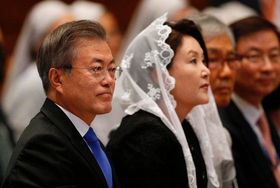 South Korean President Moon Jae-in, left, attends a Mass for peace for the Korean peninsula in St. Peter's Basilica at the Vatican