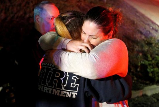 A woman who fled the Borderline Bar and Grill is embraced by a first responder Nov. 8 outside the Borderline Bar and Grill in Thousand Oaks, Calif., after a gunman killed at least 13 people. The gunman, who opened fire without warning late Nov. 7, was found dead inside the establishment, authorities said.