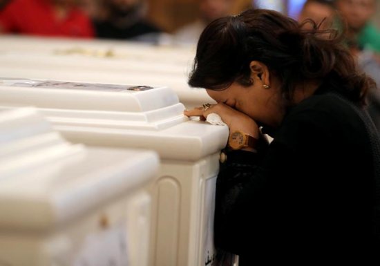 A woman mourns during a Nov. 3 funeral Mass at Prince Tadros Orthodox Church in Minya, Egypt, for a group of Christian pilgrims killed by gunmen as they headed to a monastery