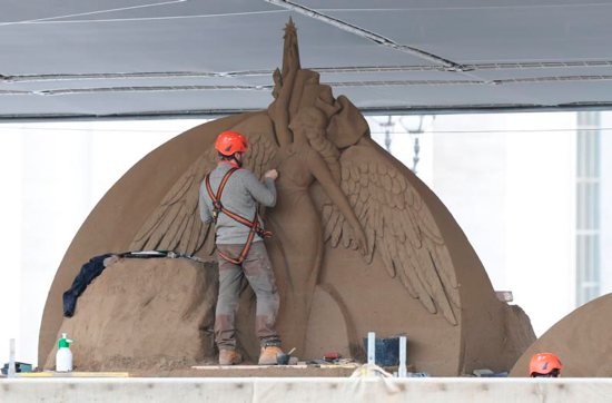 A workers sculpts an angel on a Nativity scene made entirely of sand in St. Peter's Square at the Vatican Nov. 26. The 52-foot wide sculpture is made of sand from Jesolo, an Italian seaside town near Venice.