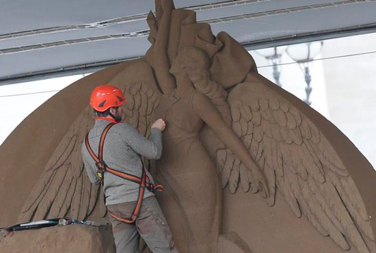 A worker sculpts an angel on a Nativity scene made entirely of sand in St. Peter's Square at the Vatican Nov. 26. The 52-foot wide sculpture is made of sand from Jesolo, an Italian seaside town near Venice. 