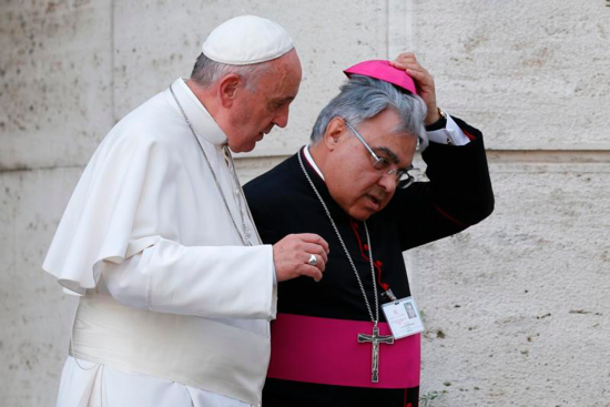 In this 2015 file photo, Pope Francis and Italian Bishop Marcello Semeraro of Albano leave the opening session of the Synod of Bishops on the family at the Vatican.