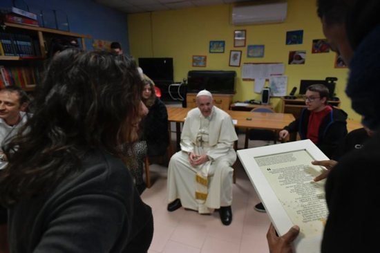 Pope Francis visits mentally disabled people at Il Ponte e l'Albero community on the outskirts of Rome Dec. 7. The visit continued the pope's tradition of doing Friday works of mercy.