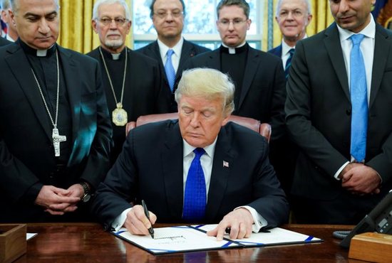 At the White House Dec. 11, President Donald Trump signs into law the Iraq and Syria Genocide Relief and Accountability Act of 2018, which will provide humanitarian relief to genocide victims in Iraq and Syria and hold accountable Islamic State perpetrators of genocide.