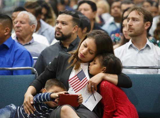 Immigrants are seen Aug. 24 during a naturalization ceremony in Los Angeles. A Trump administration proposal to deny green cards to legal immigrants using public assistance "will dramatically change the process of legal migration and make it increasingly difficult for low-income and working-class individuals to legally migrate to the United States."