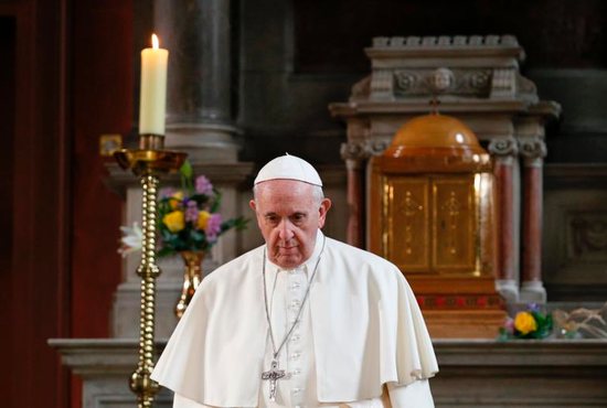 Pope Francis walks in front of a candle in memory of victims of sexual abuse as he visits St. Mary's Pro-Cathedral in Dublin Aug. 25. Pope Francis apologized for clerical sexual abuse in Ireland but on the final day of the trip, he was accused of ignoring abuse by Cardinal Theodore E. McCarrick. 
