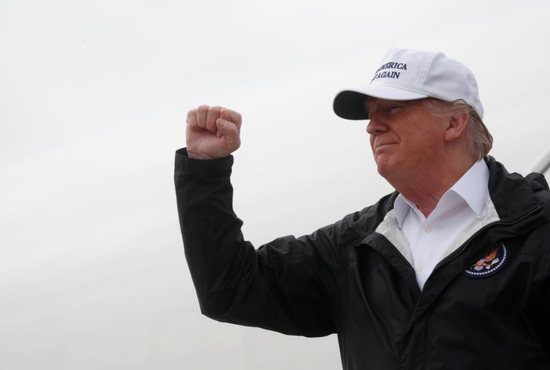 President Donald Trump pumps his fist as he arrives for a Jan. 10 visit to the U.S.-Mexico border at McAllen-Miller International Airport in McAllen, Texas. He planned to visit to the Humanitarian Respite Center in McAllen Jan. 10. A day earlier Sister Norma Pimentel, executive director of Catholic Charities of the Rio Grande Valley in the Diocese of Brownsville, Texas, welcomed the president to the border in a newspaper op-ed and invited him to see the center's work in assisting people from Central America who are seeking asylum in the U.S. 