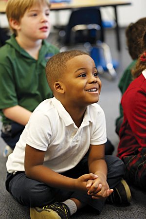 Kindergartner Levi Brown of Faithful Shepherd Catholic School in Eagan reacts to the reading of the story “Nicky and the Rainy Day” by his teacher, Kathy Malmquist, during class 