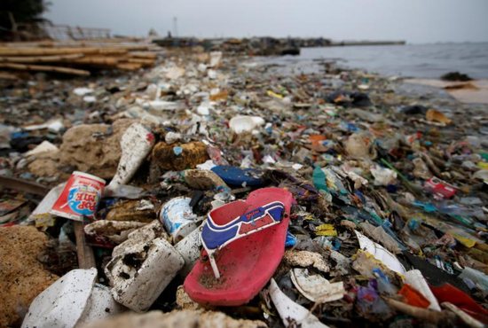 Plastic and styrofoam garbage litters the shoreline in 2018 in Jakarta, Indonesia. Months after Indonesia's military was summoned to unclog Jakarta Bay, Archbishop Ignatius Suharyo joined a chorus of disapproval of the nation's growing plastic waste problem by calling parishioners to action.
