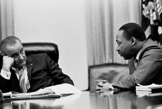 Civil rights leader the Rev. Martin Luther King Jr. talks with U.S. President Lyndon B. Johnson in this undated photo. Johnson signed the Civil Rights Act into law July 2, 1964. Martin Luther King Jr. Day is celebrated Jan. 21 this year.