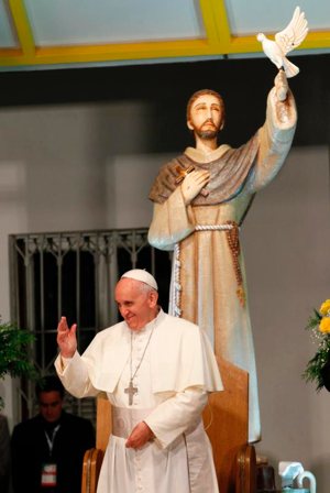 Pope Francis waves near a statue of St. Francis of Assisi as he meets with patients at a hospital in Rio de Janeiro July 24, 2013. The pope will have St. Francis of Assisi on his mind when he visits Abu Dhabi Feb. 3-5 and Morocco in late March. 