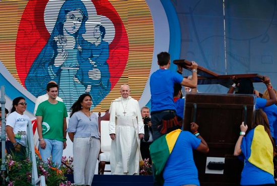Pope Francis watches as young people carry the World Youth Day cross and icon during a welcoming ceremony and gathering with young people in Santa Maria la Antigua Field in Panama City Jan. 24, 2019.