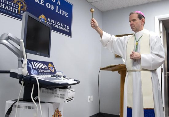 Bishop Michael F. Burbidge of Arlington, Va., blesses the new ultrasound machine for the Mother of Mercy Free Clinic in Manassas Jan. 14, 2019. 