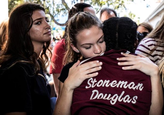 Students from Marjory Stoneman Douglas High School attend a memorial Feb. 15, 2018, following a school shooting in Parkland, Fla. Feb. 14 marks the first anniversary of the shooting that killed 14 students and three staff members at the school. 